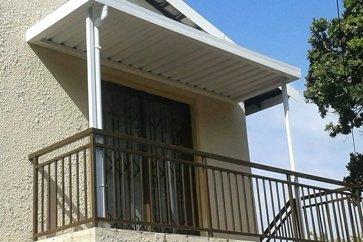 White steel awning installed over a balcony