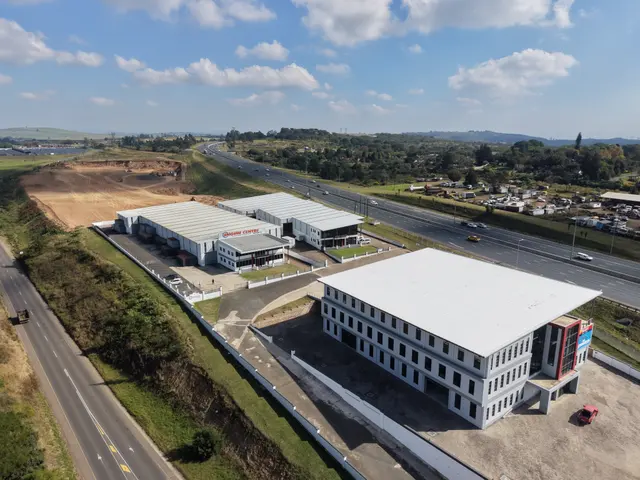 The Engen Centre buildings beside the highway, white steel roofs