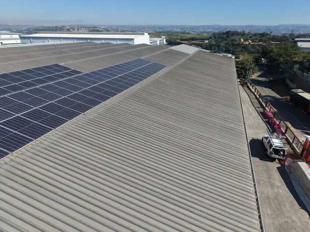 Aerial view along the charcoal-clad Roofco factory roof line