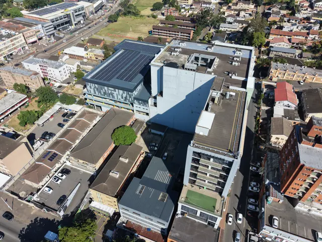 Sparks Mall roof fully covered in solar panels, residential tower behind